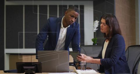 Diverse Business Team Reviewing Digital Data with Tablet