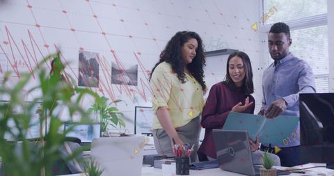 Diverse Team Discussing Data in Modern Office Environment