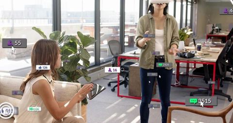 Coworkers Collaborating with VR Headset and Tablet in Open-Plan Office with AR UI Overlays