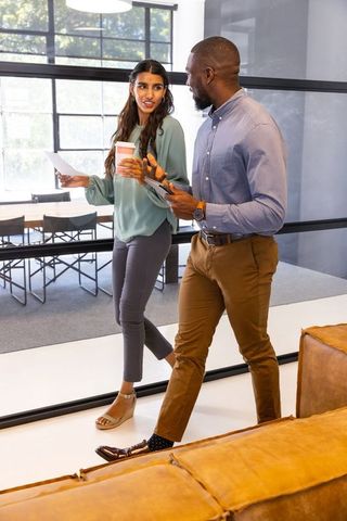 Diverse Coworkers Walking in Modern Office Environment