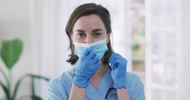 Smiling Nurse Wearing Face Mask and Latex Gloves Indoors - Download Free Stock Images Pikwizard.com