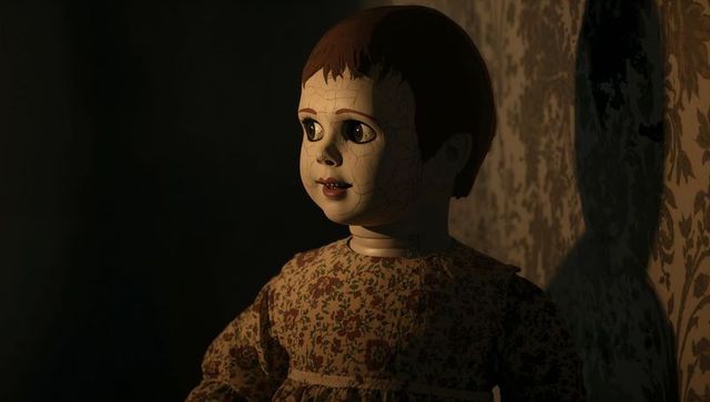 Eerie porcelain doll with cracks in vintage dress