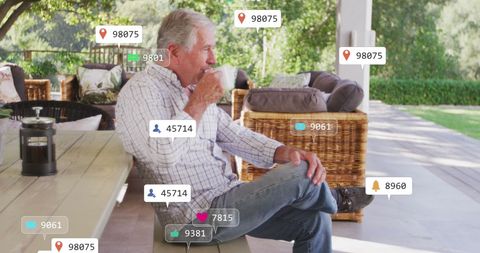Senior man engaging with virtual social media overlay outside