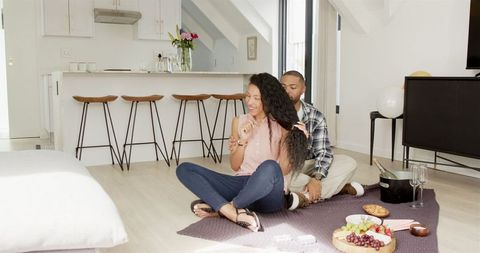 Couple celebrating at home with surprise gift