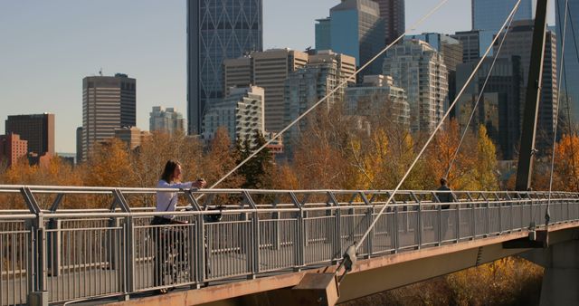 Woman Taking Photos on Bridge with Urban Skyline Background - Download Free Stock Images Pikwizard.com