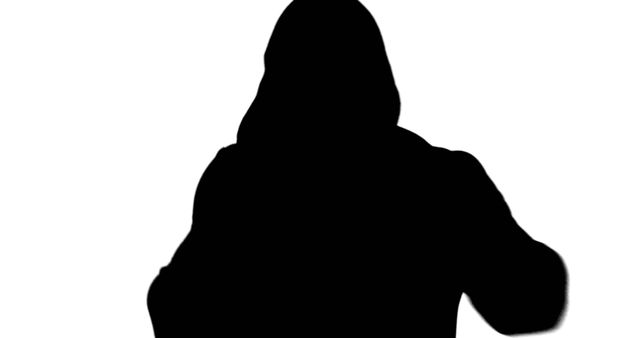 Silhouette of an unidentifiable person wearing a hoodie, with copy space. The image conveys a sense of mystery or anonymity.