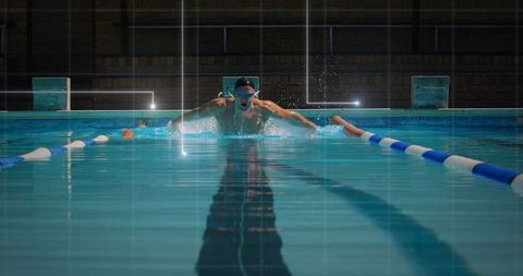 Competitive swimmer executing butterfly stroke in pool streamline