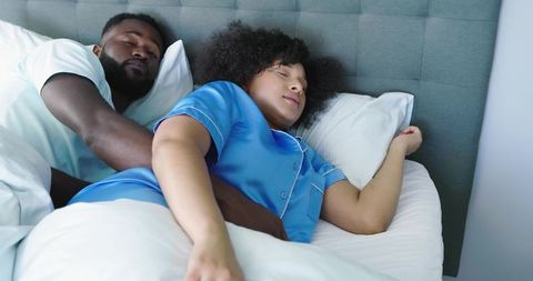Couple Cuddling in Bed Wearing Blue Satin Pajamas Cozy Calm Morning Intimacy