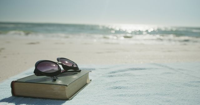 Sunglasses on Book at Beach, Relaxing Summer Vacation Scene - Download Free Stock Images Pikwizard.com