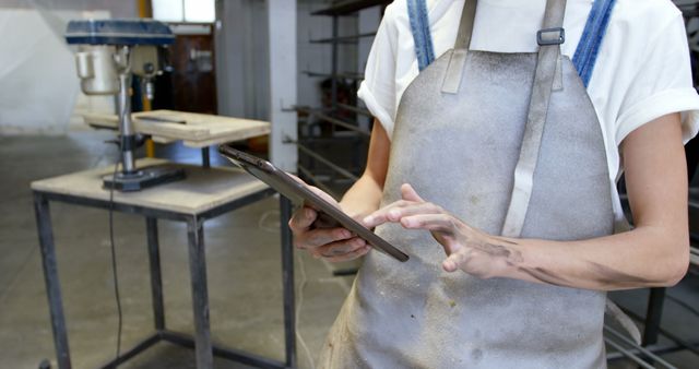 Craftsperson Using Digital Tablet in Workshop for Precision Work - Download Free Stock Images Pikwizard.com