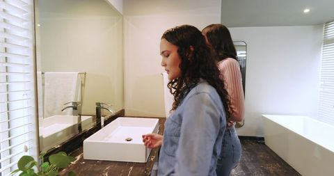Friends by modern bathroom vanity with elegant vessel sink