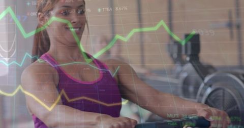 Woman exercising on rowing machine with financial data overlay