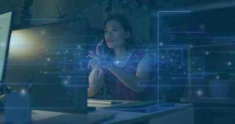 Woman Engaged with Futuristic Holographic Interface in Modern Office