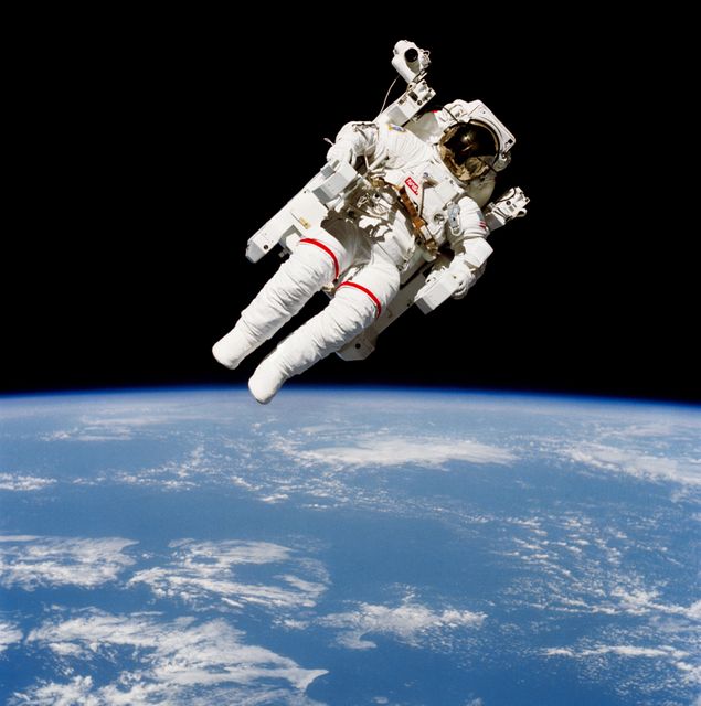 S84-27017 (7 Feb. 1984) --- Astronaut Bruce McCandless II, one of two 41-B mission specialist, participating in a historical Extravehicular Activity (EVA), is a few meters away from the cabin of the Earth-orbiting space shuttle Challenger in this 70mm frame. This EVA represented the first use of a nitrogen-propelled, hand-controlled device called the Manned Maneuvering Unit (MMU), which allows for much greater mobility than that afforded previous spacewalkers who had to use restrictive tethers. Robert L. Stewart, mission specialist, later tried out the MMU McCandless is using here. The two of them tested another similar unit two days later. Inside the spacecraft were astronauts Vance D. Brand, commander; Robert L. Gibson, pilot; and Ronald E. McNair, mission specialist. Photo credit: NASA
