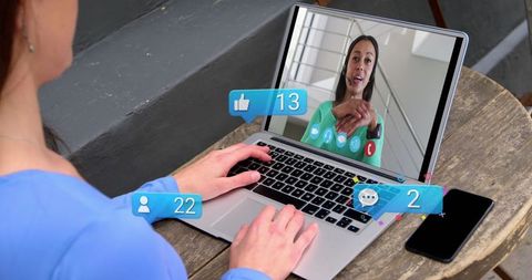 Social Media Interaction During Video Call on Laptop at Cafe