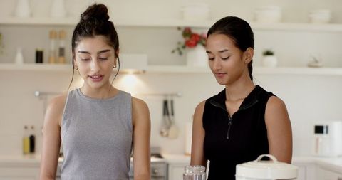 Diverse women collaborating in modern kitchen