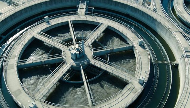 Aerial rotating clarifier at wastewater plant with circular sedimentation basin and radial bridge