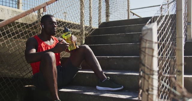 Tired Athlete Resting on Stairs and Drinking Water - Download Free Stock Images Pikwizard.com