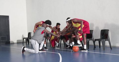 Diverse basketball team unites in pre-game huddle