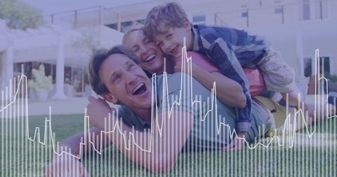 Happy Family Enjoys Outdoor Play on Grassy Lawn