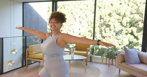 Woman Exercising in Modern Living Room with Smartwatch Tracker