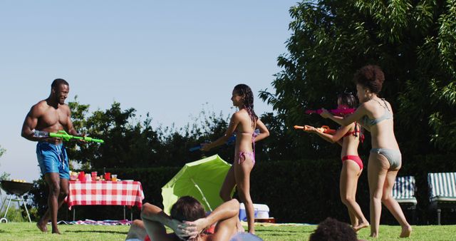 Friends Playing Water Gun Fight at Summer Pool Party - Download Free Stock Images Pikwizard.com