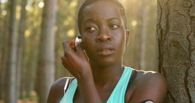 Young Woman Preparing for Run in Forest Setting Sun - Download Free Stock Images Pikwizard.com