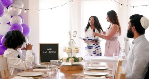 Family Celebrating Bat Mitzvah with Decorations and Speech