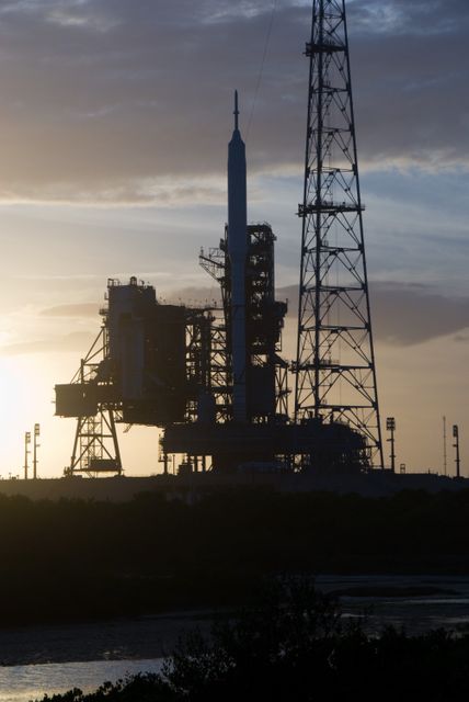 Ares I-X rocket sits on Launch Pad 39B at NASA's Kennedy Space Center during sunset, highlighting its readiness for liftoff. This historic moment represents a milestone in the Constellation Program, echoing the era of Apollo Program's Saturn rockets. This image can be used in articles discussing the evolution of space exploration, the History of NASA, and the advancements in space technology.