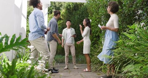 Friends Enjoying Outdoor Gathering Surrounded by Lush Greenery