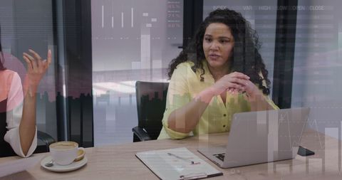 Diverse Businesswomen in Office Analyzing Financial Data