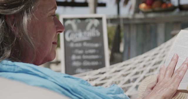 Senior Woman Relaxing in Hammock and Reading Book Outdoors - Download Free Stock Images Pikwizard.com