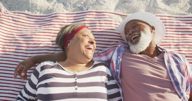 Senior Couple Relaxing on Beach Blanket Laughing and Enjoying Time Together - Download Free Stock Images Pikwizard.com