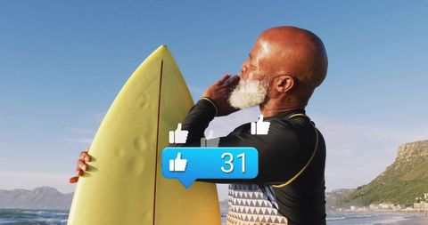 Senior surfer emulating success on sunny cliffside beach