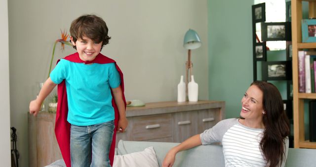 Happy Boy Playing Superhero with Cape on Couch - Download Free Stock Images Pikwizard.com