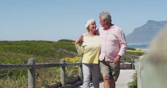 Senior Couple Enjoying a Walk on the Beach Path - Download Free Stock Images Pikwizard.com