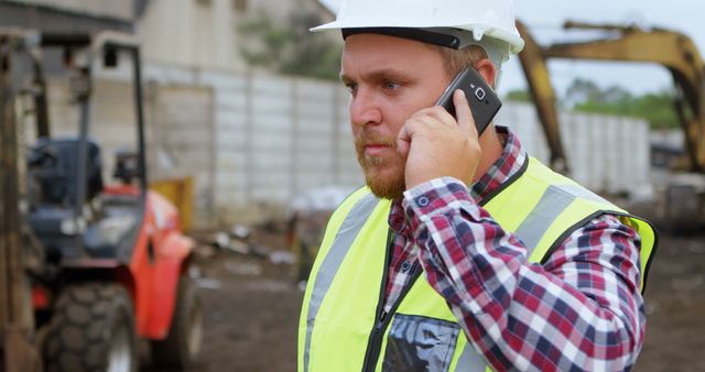 Caucasian Male Worker Communicating in Industrial Scrap Yard - Download Free Stock Images Pikwizard.com