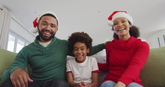 Smiling Family Celebrating Christmas Together on Sofa - Download Free Stock Images Pikwizard.com