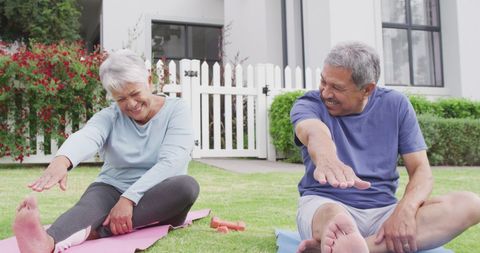 Happy Senior Couple Practicing Yoga Outdoors