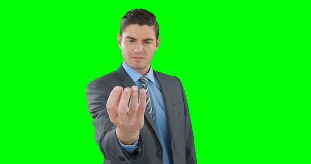 Businessman holding out hand in front of green screen background - Download Free Stock Images Pikwizard.com