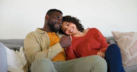 Happy Couple Embracing on Cozy Sofa at Home