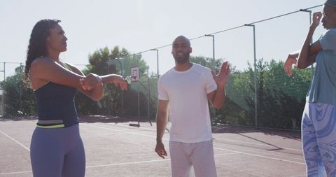 Basketball team strategy discussion on sunny outdoor court