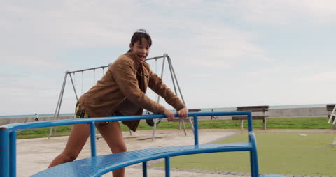 Joyful Children Spinning on Playground Merry-Go-Round