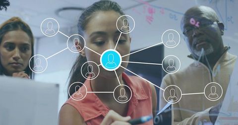 Diverse team networking strategy planning on glass board