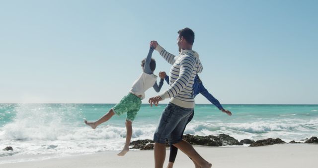 Family Playing on Sunny Beach with Ocean Waves - Download Free Stock Images Pikwizard.com