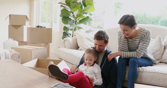 Happy Family Relaxing in Their New Home with Moving Boxes - Download Free Stock Images Pikwizard.com