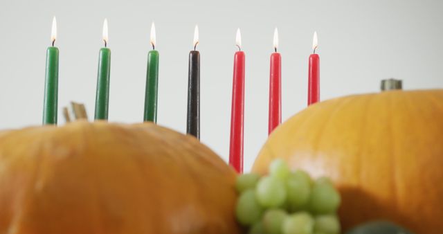Composition of seven lit candles and halloween pumpkins and grapes - Download Free Stock Photos Pikwizard.com