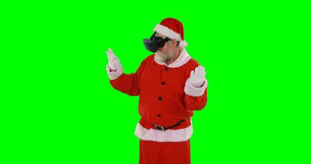 A person dressed in a Santa Claus costume is standing against a green screen background, with copy space. The individual is making a gesture, preparing for a holiday-themed production or advertisement.