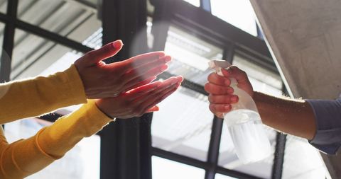 Diverse Hands Practicing Hygiene with Sanitizer Spray Indoors - Download Free Stock Images Pikwizard.com