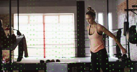 Focused health enthusiast exercising on plyometric box in boxing gym